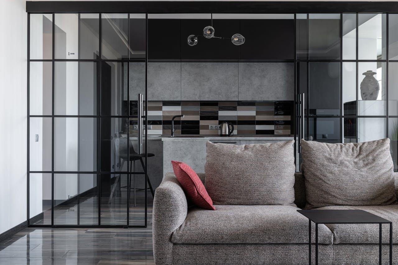 services-cta Contemporary living room with cozy sofa and open kitchen view.